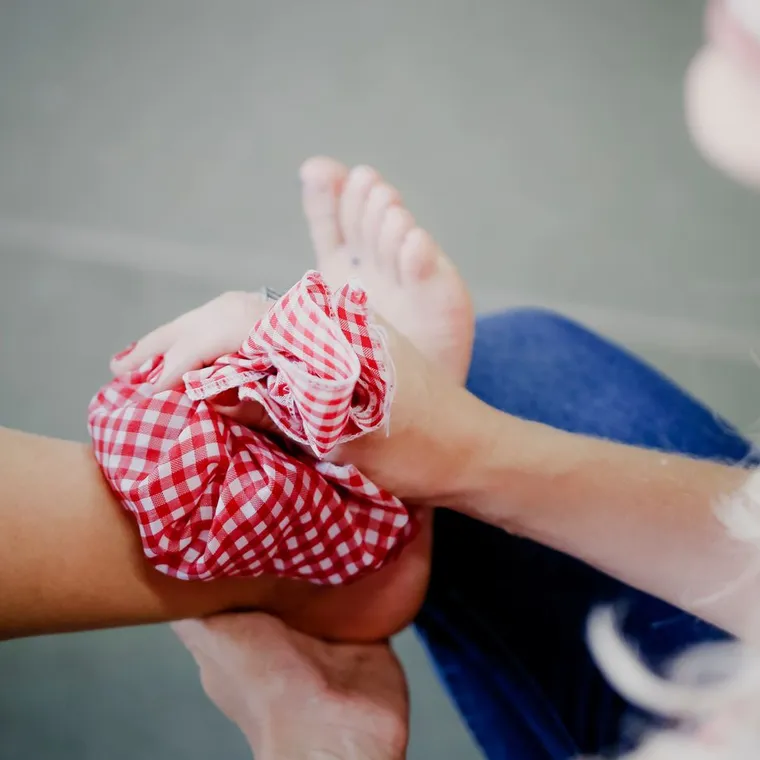 A cold pack wrapped against a person's ankle after a minor injury