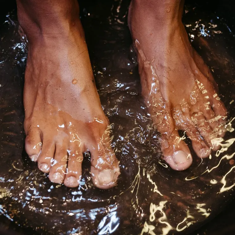 Feet soaking in a warm foot bath at home in the evening